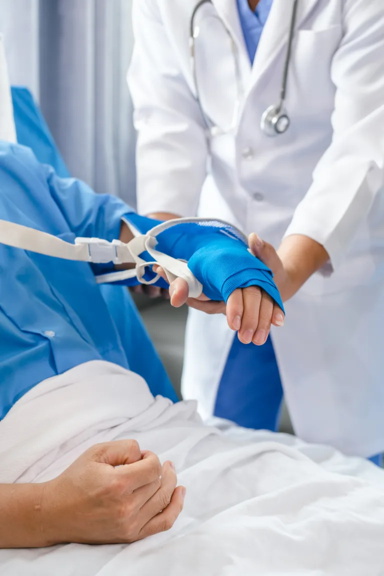 The medical team visits the car accident patients who are lying on the nursing bed and arm cast with wrapping nurse bandages splint to the arm.