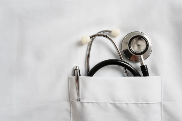 stethoscope and pen in doctor robe pocket