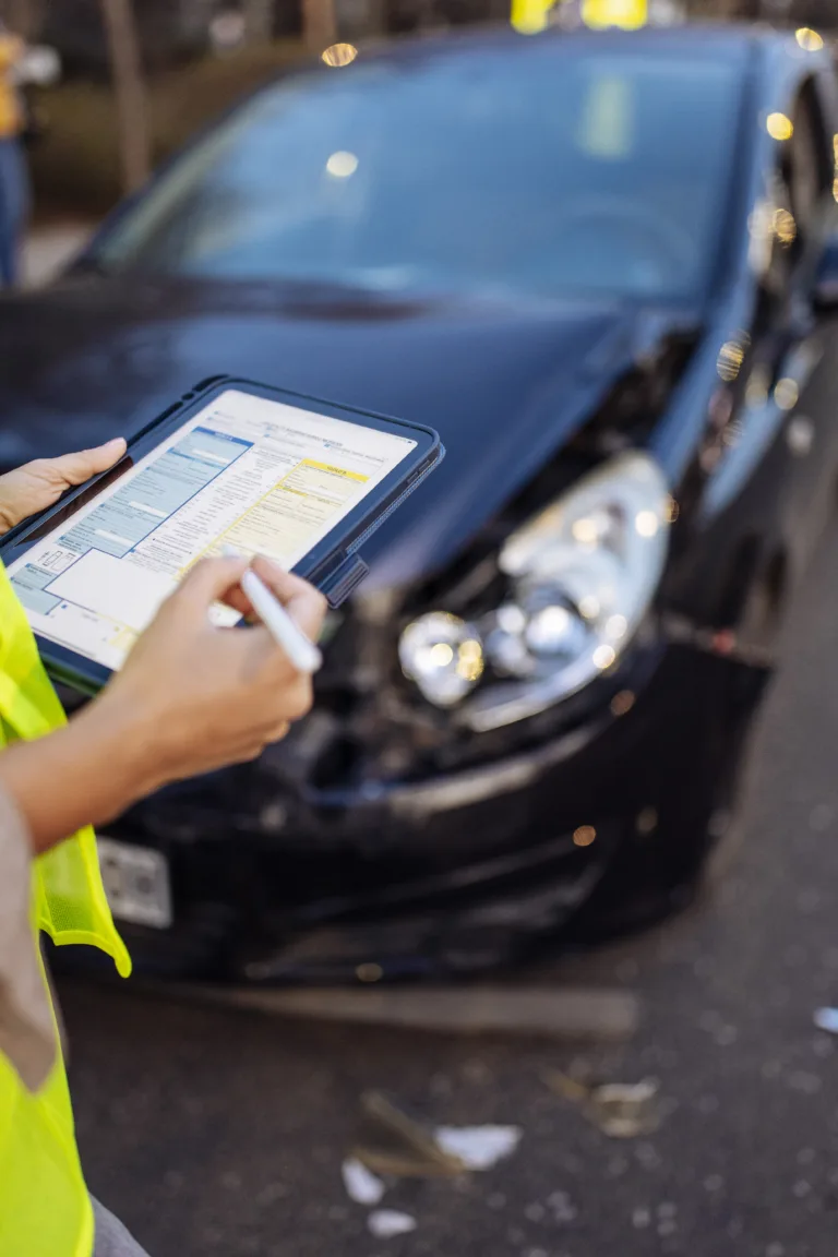 Close up of Woman's hands filling accident report after car crash